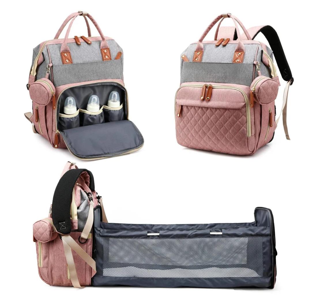 Multifunctional diaper bag with organizer, bottles, and baby crib extension on a white background